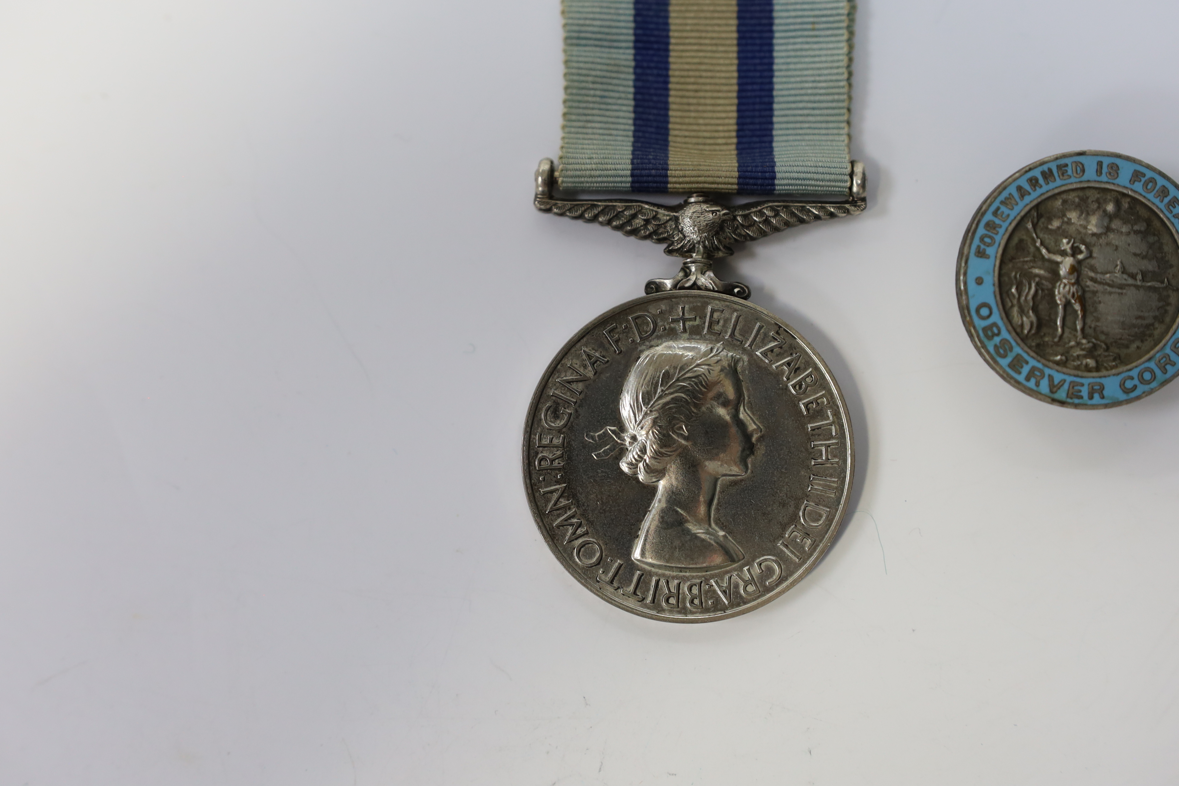 An ERII (B) Royal Observer Corps medal to Observer W.Cook with a lapel badge. Condition - fair.